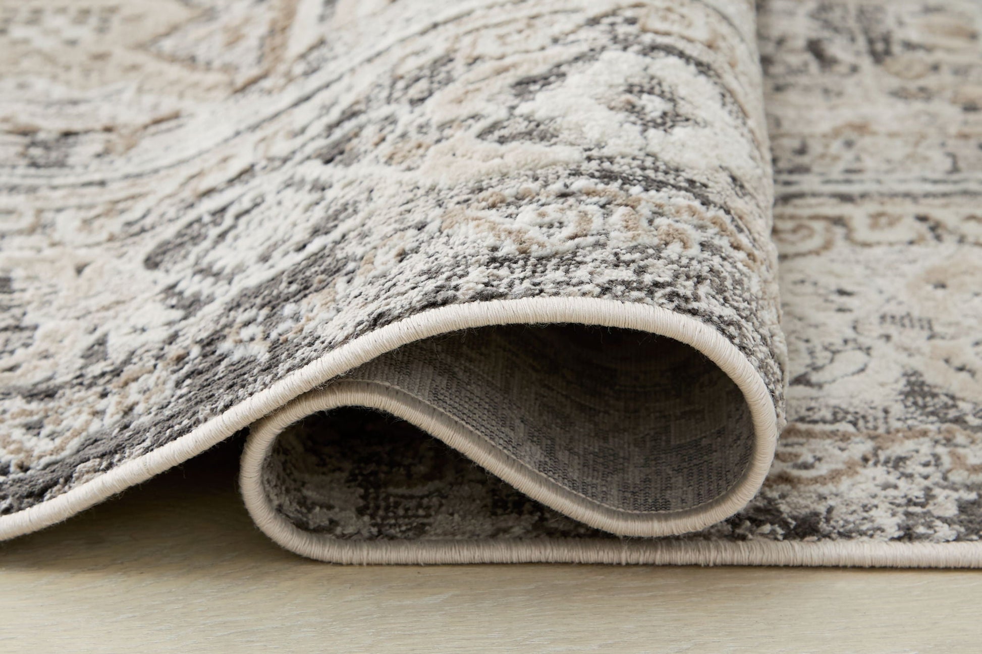 Junley rug from Unique Piece Furniture in beige gray with an abstract pattern, rolled edge on Tampa Home & Garden Store