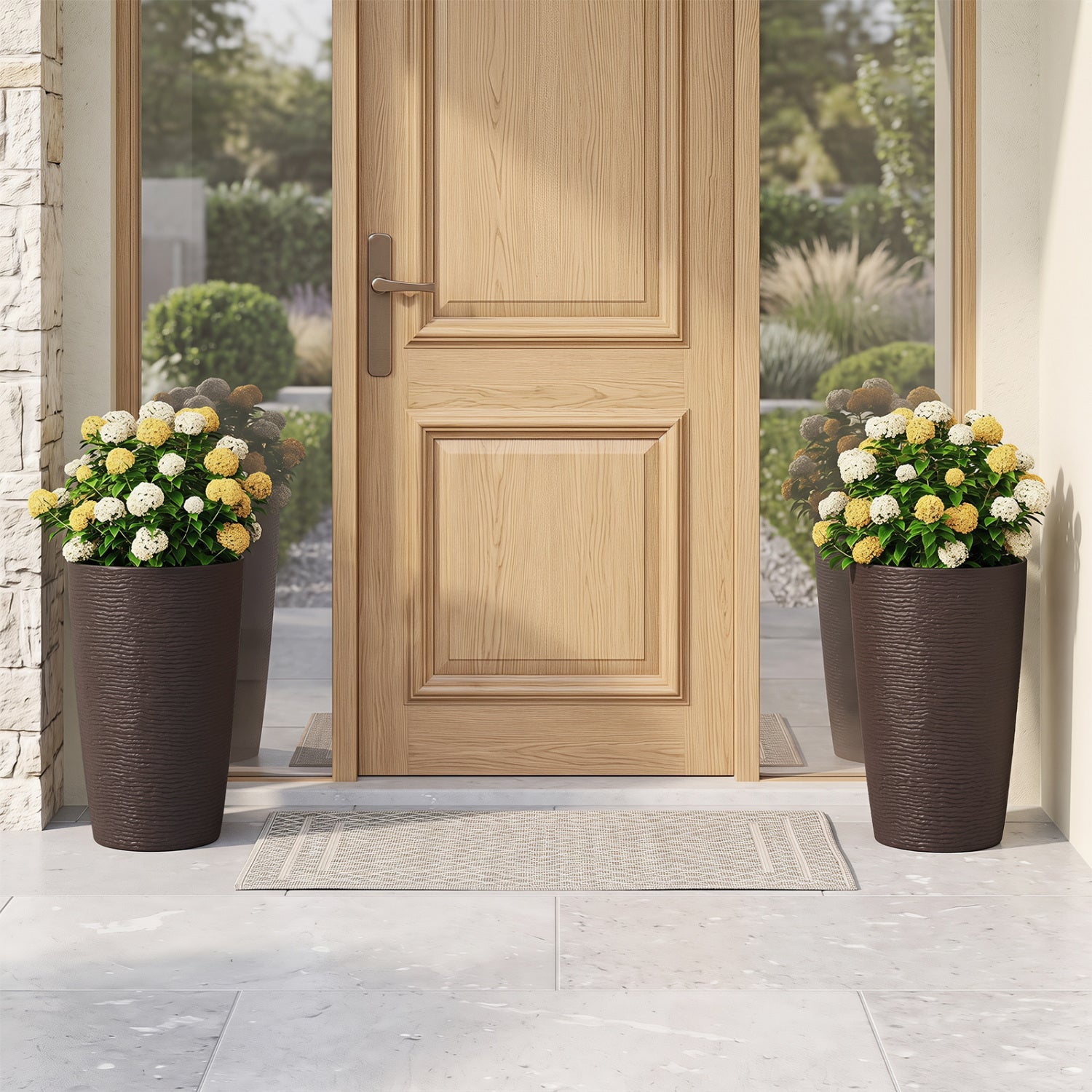 Round plastic planters set of 2, 21-inch tall, dark brown textured pots with white and yellow blooms at front door on Tampa Home & Garden Store