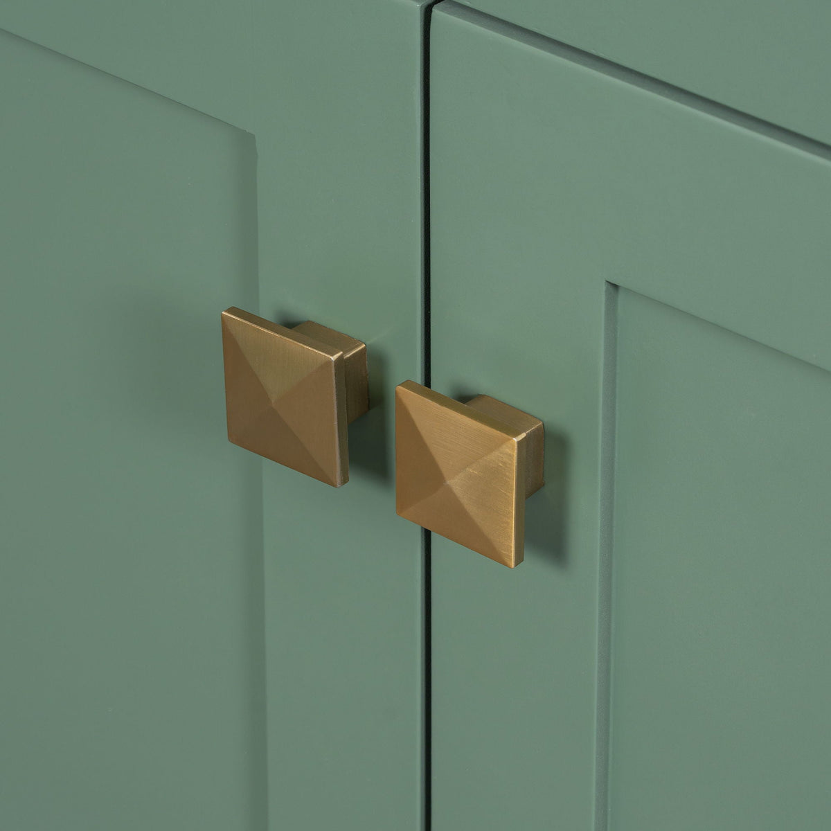 Modern bathroom vanity with green cabinet doors and brass square pulls on Tampa Home & Garden Store