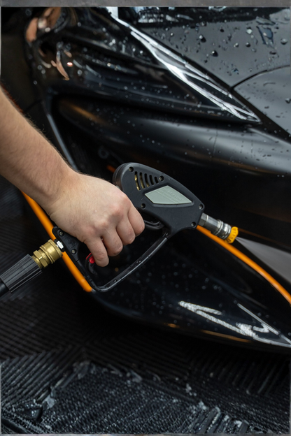 BLACKLINE® snub-nose pressure washer gun, black handheld unit with orange hose beside a wet black car on Tampa Home & Garden Store