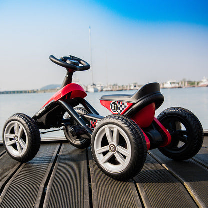 Kids' Pedal Go-Kart by UpTrend Deals, red and black four-wheel ride-on toy with racing decals on a wooden dock by the water on Tampa Home & Garden Store