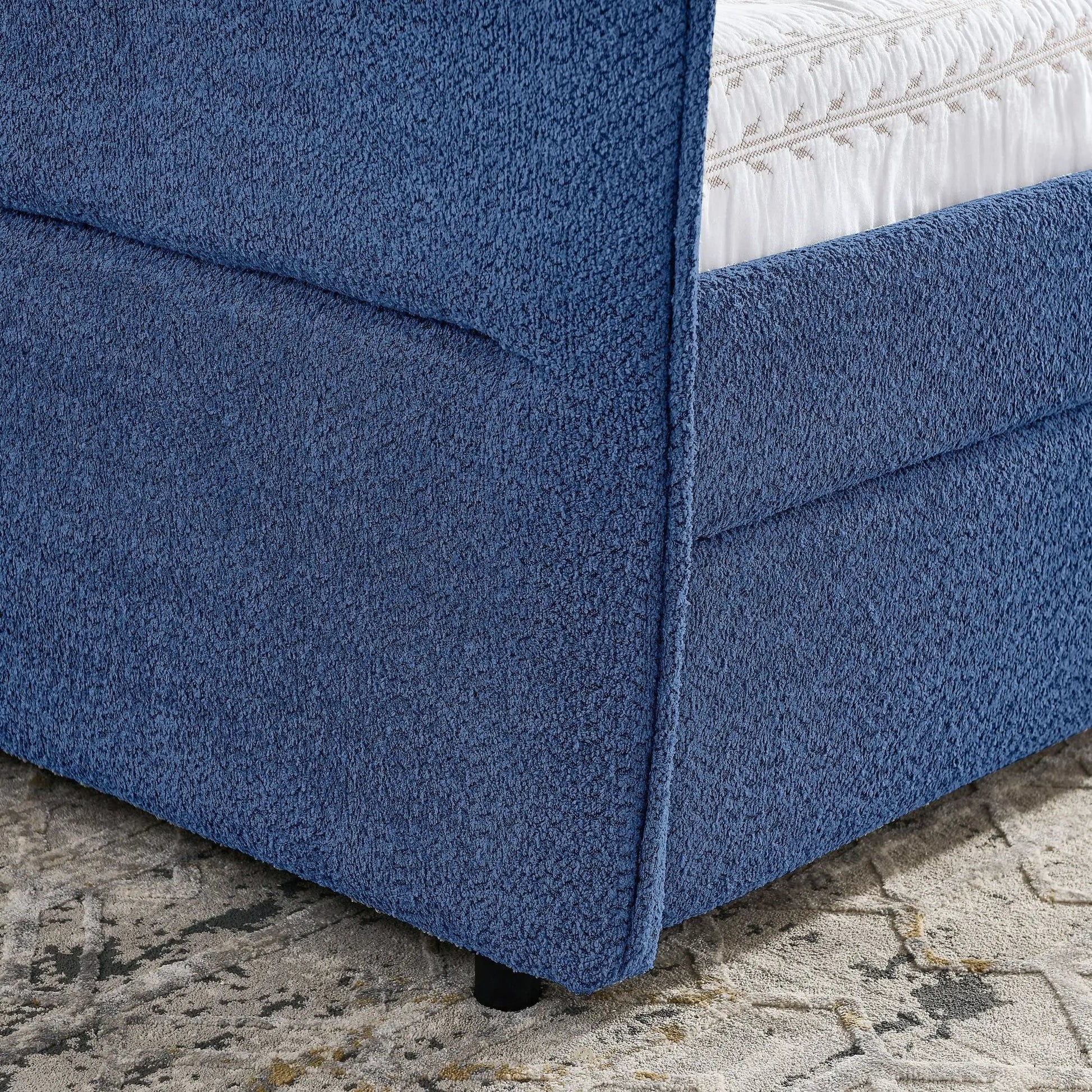 Upholstered blue daybed with 2 drawers, textured fabric and white quilted bedding visible on Tampa Home & Garden Store