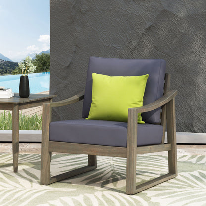 Samwell Outdoor Club Chair with gray cushions and lime pillow, wooden frame by pool on Tampa Home & Garden Store
