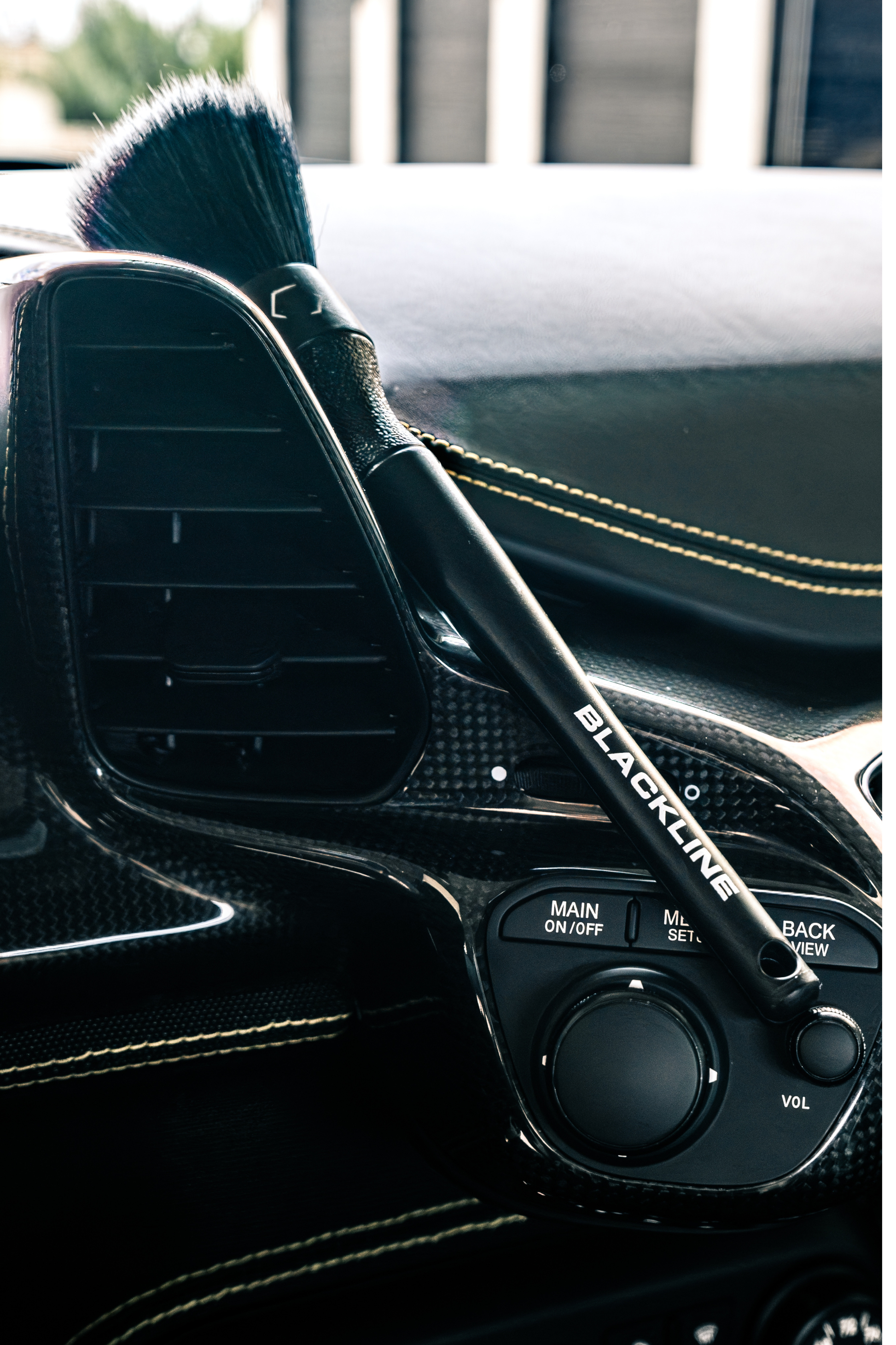 Blackline Car Care Ultra-Soft Detail Brush with black handle resting on a car dashboard on Tampa Home & Garden Store