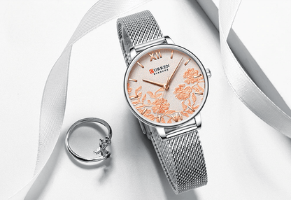Womens watch with peach floral decoupage dial and silver mesh band Curren logo; ring nearby on Tampa Home & Garden Store