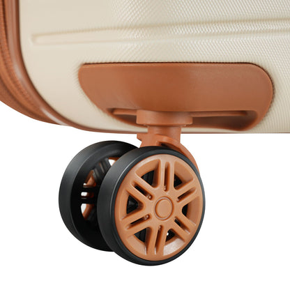 Tan hard-shell luggage wheel assembly with black rims close-up view on Tampa Home & Garden Store