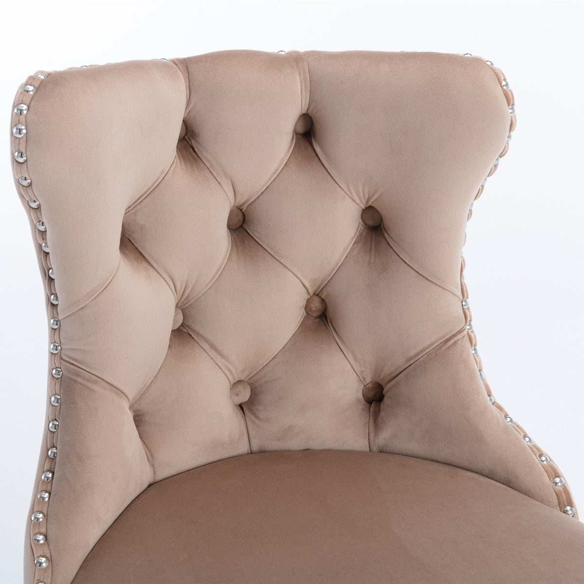Beige tufted chair close-up with button tufting and silver nailhead trim along edges on Tampa Home & Garden Store