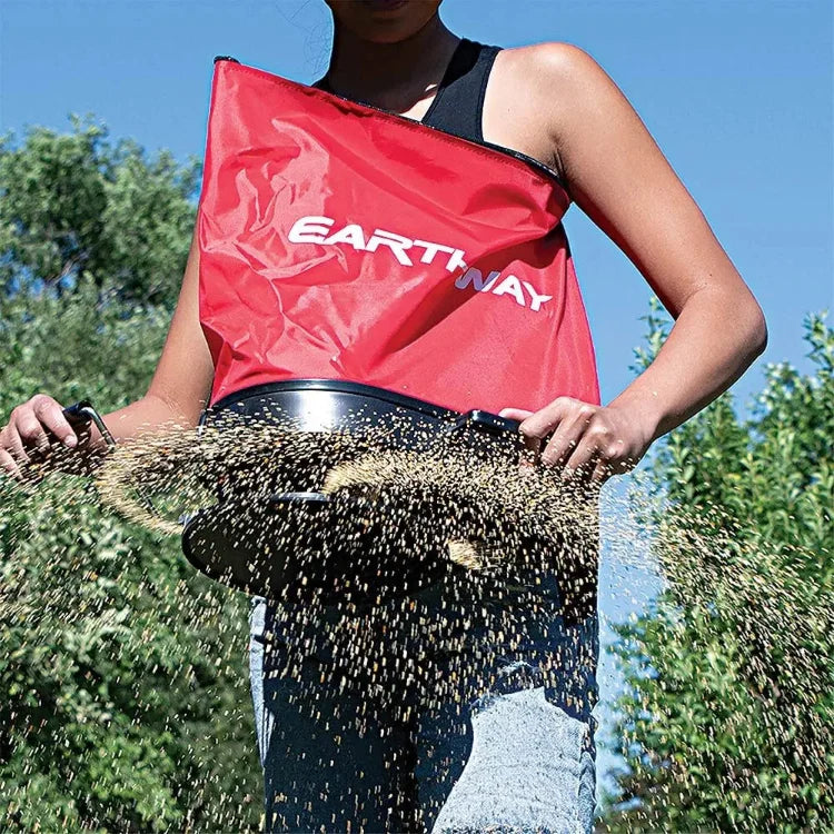 Earthway Over Shoulder Bag Spreader red over-shoulder seed spreader worn by gardener dispersing seeds on Tampa Home & Garden Store