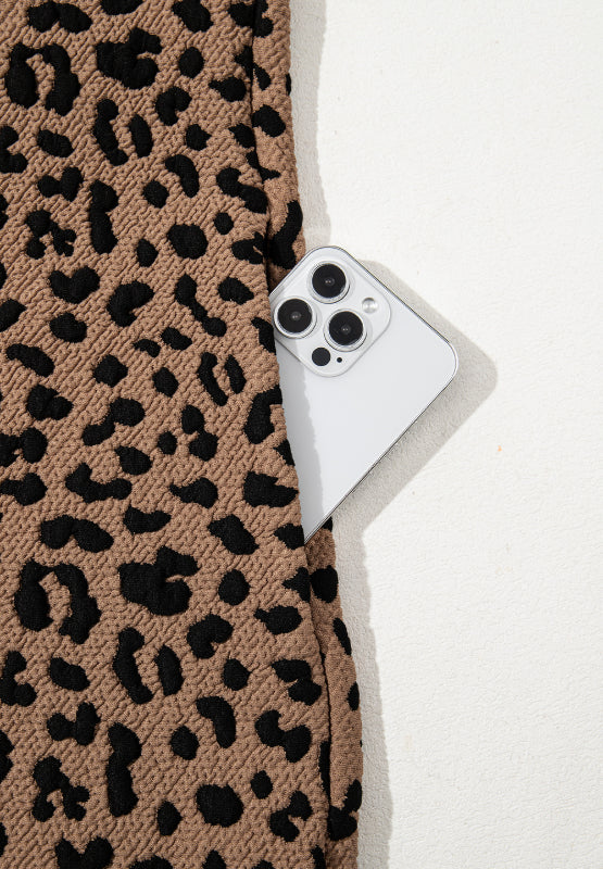 Stevvex leopard print dress fabric swatch with a smartphone peeking from behind on Tampa Home & Garden Store