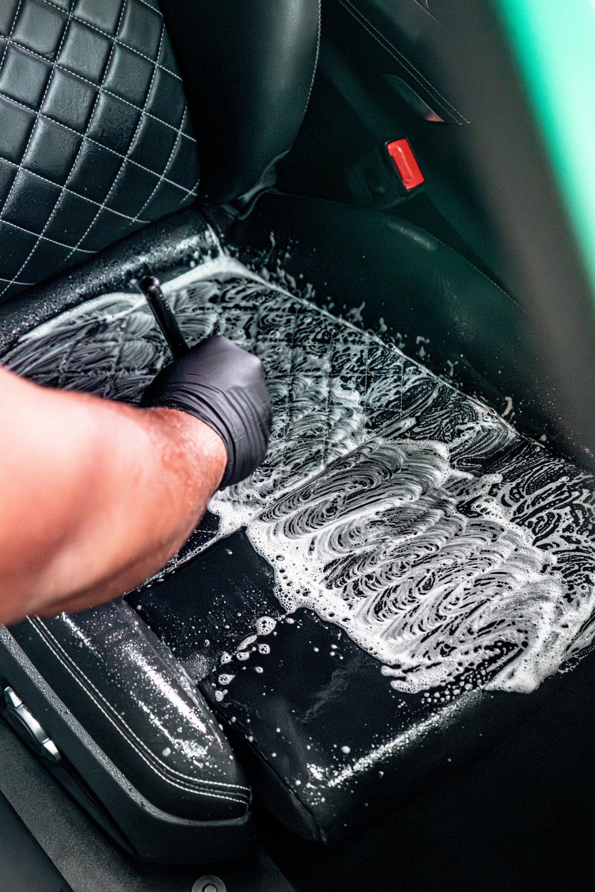 BLACKLINE Ultra-Soft Detail Brush used to scrub a black car interior seat with foam on Tampa Home & Garden Store