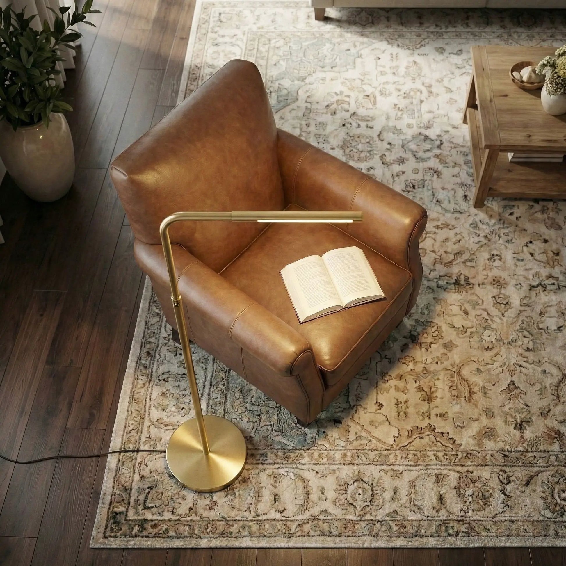 Verve floor lamp with gold finish and curved arm; round base beside a leather chair on Tampa Home & Garden Store