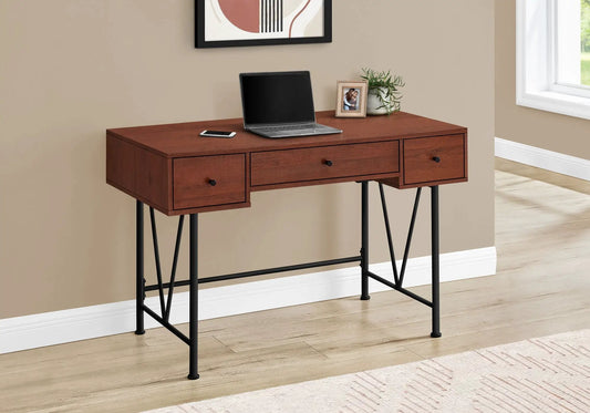 Computer desk with warm wood finish, 3 drawers, black legs; laptop, plant, photo frame on Tampa Home & Garden Store