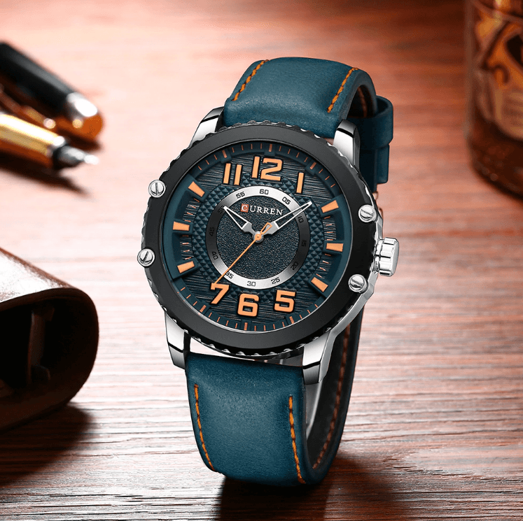 Men's waterproof sport watch by Stevvex with blue leather strap and large orange numerals on Tampa Home & Garden Store