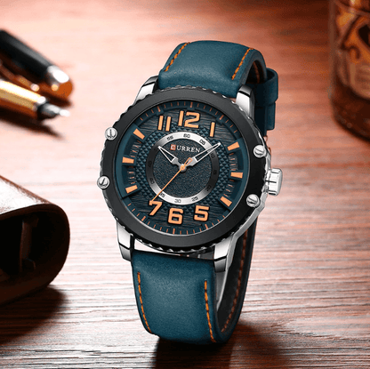 Men's waterproof sport watch by Stevvex with blue leather strap and large orange numerals on Tampa Home & Garden Store