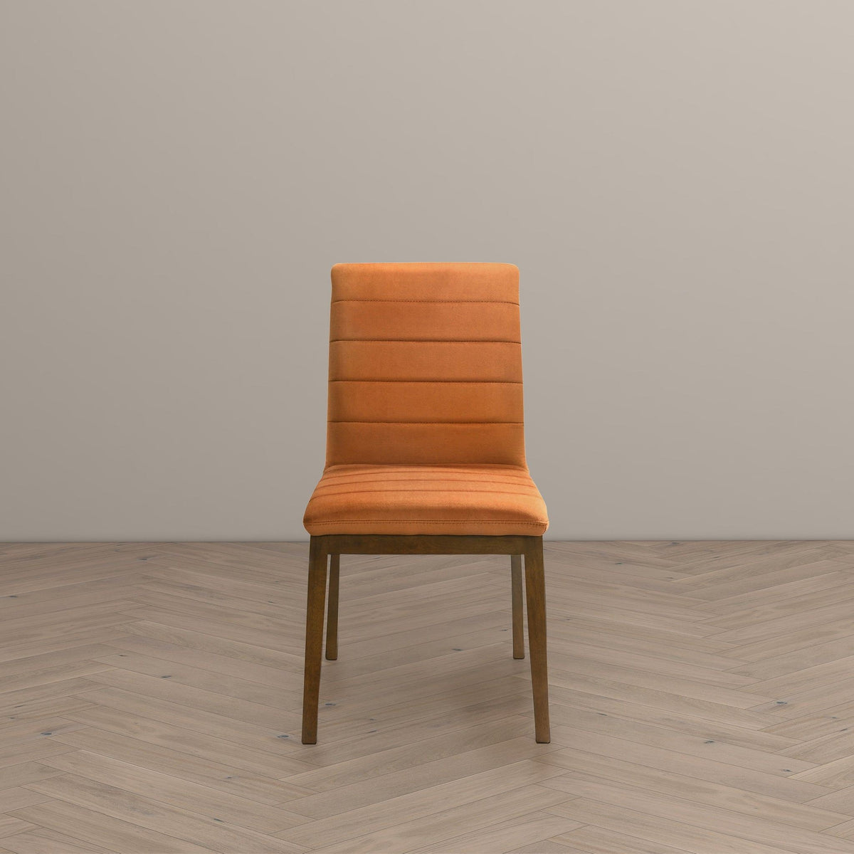 Orange upholstered dining chair with solid wood legs in a minimalist setting on Tampa Home & Garden Store