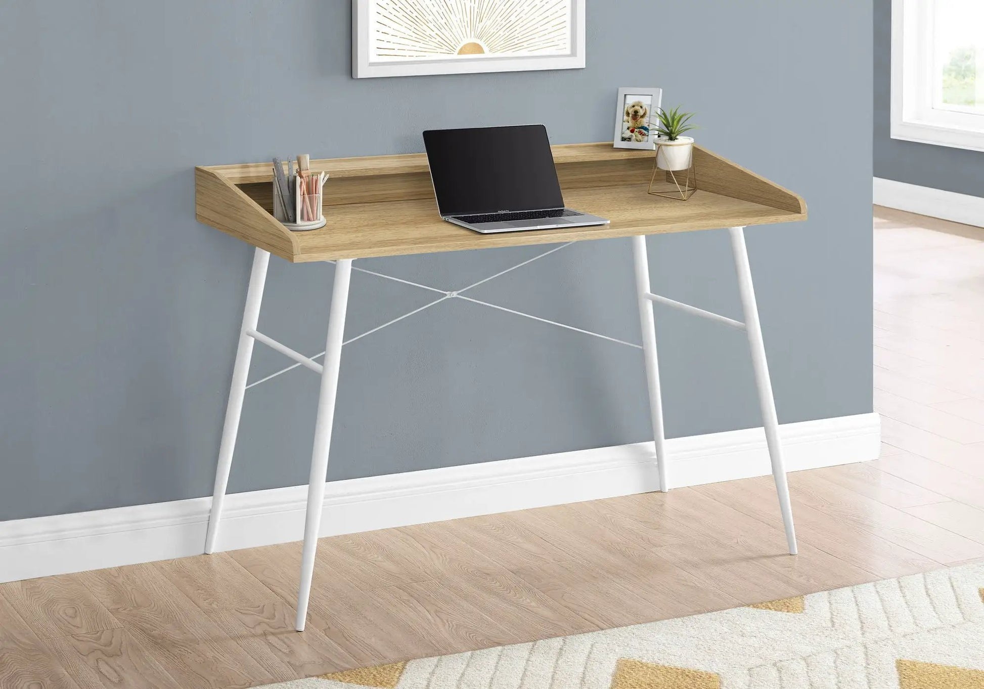 Computer desk in natural wood finish with built-in storage shelves and white legs, laptop on top on Tampa Home & Garden Store