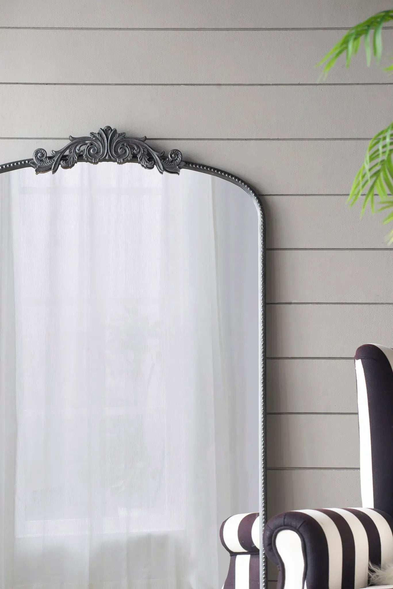 Arch Mirror with ornate Baroque silver frame and curved top, white sheer curtain backdrop on Tampa Home & Garden Store