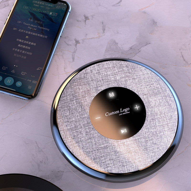Waterproof Bluetooth speaker with fabric texture and logo, round design on Tampa Home & Garden Store