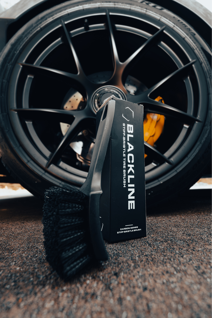 BLACKLINE Stiff Bristle Tire Brush with dense black bristles beside a dark alloy wheel on Tampa Home & Garden Store