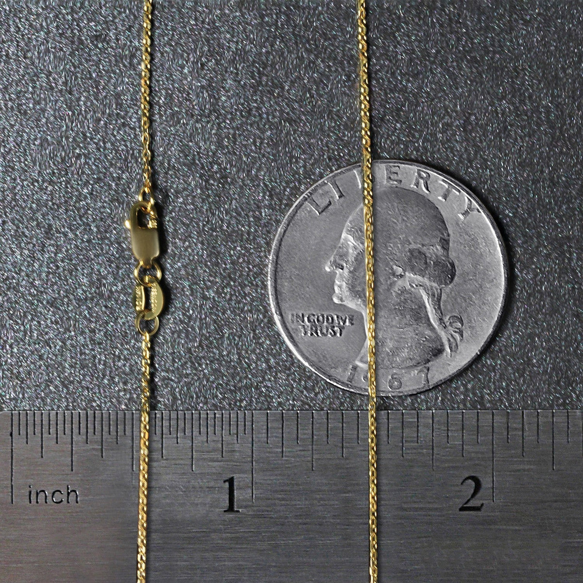 14k yellow gold diamond-cut cable link necklace, 0.8mm, with clasp beside a quarter for scale on Tampa Home & Garden Store