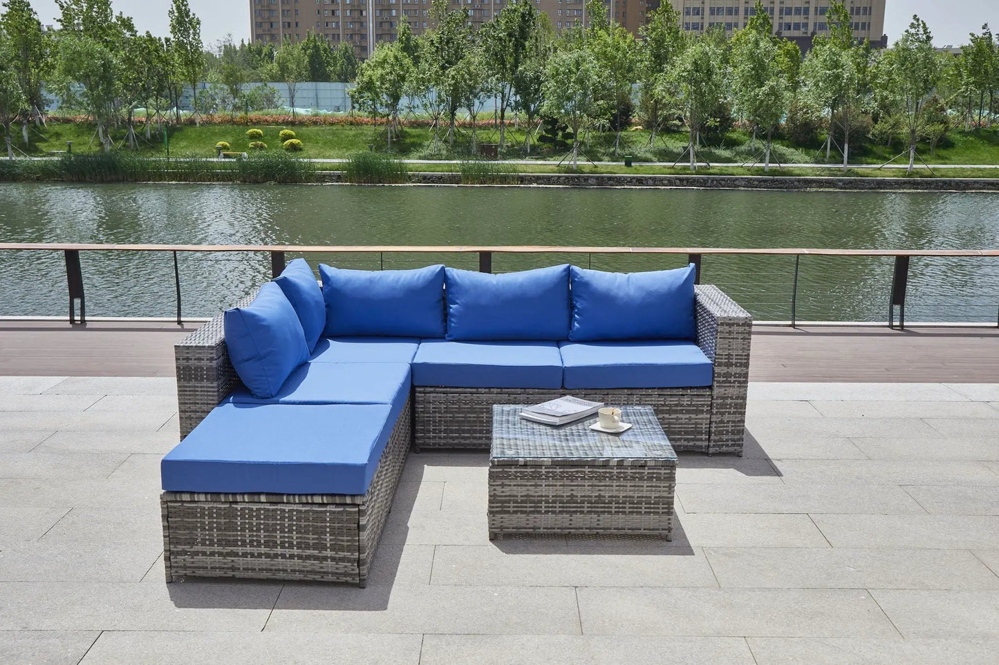 Patio sofa with cushions, blue cushions in a grey wicker 2-piece outdoor set on a waterfront deck on Tampa Home & Garden Store