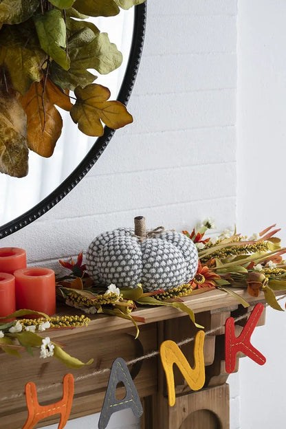 Knite pumpkin ornament, gray and white knitted pumpkin with stem on a mantel garland on Tampa Home & Garden Store