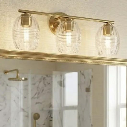 Luster 3-light vanity wall lamp with clear glass shades in satin gold finish for bathroom on Tampa Home & Garden Store