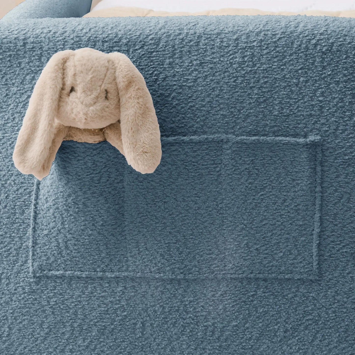 Blue textured upholstered platform bed frame with rabbit-ear detail and beige plush bunny on Tampa Home & Garden Store