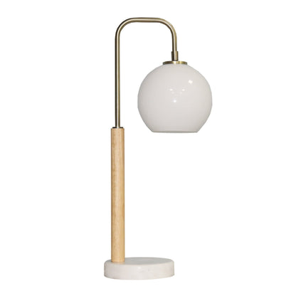 Bedside table lamp with globe white shade and brass arc frame on Tampa Home & Garden Store