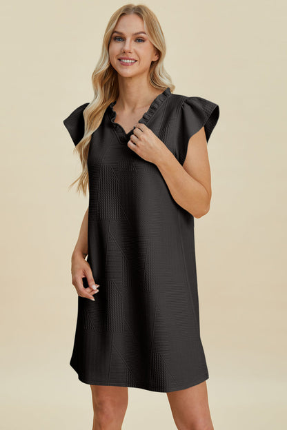 Stevvex Double Take Ruffled V-Neck Cap Sleeve Dress in black with textured panels on Tampa Home & Garden Store
