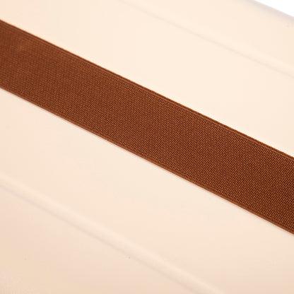 Luggage strap, brown woven belt across beige surface on Tampa Home & Garden Store