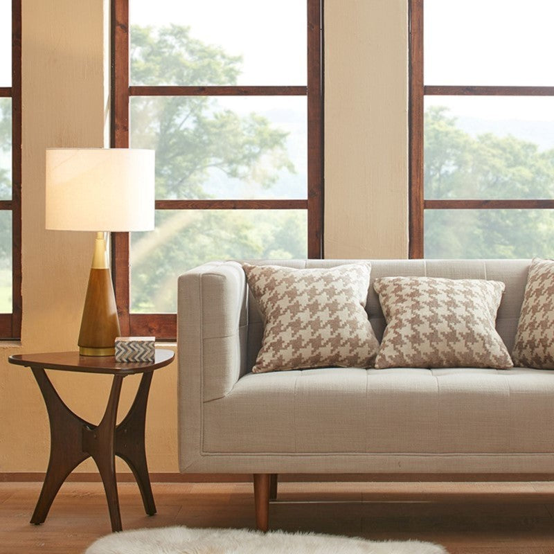 Triangular table lamp with wooden cone base and white fabric shade on a round side table on Tampa Home & Garden Store