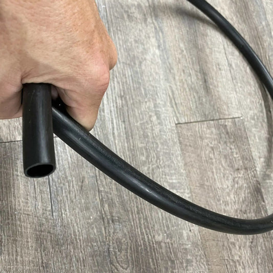 Varden irrigation parts package; black Bootstrap Farmer irrigation tubing held in hand on Tampa Home & Garden Store