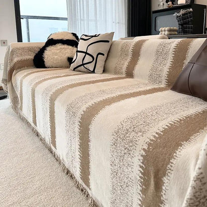 Sofa slipcover in beige and cream striped pattern with fringe edge on a living room couch on Tampa Home & Garden Store