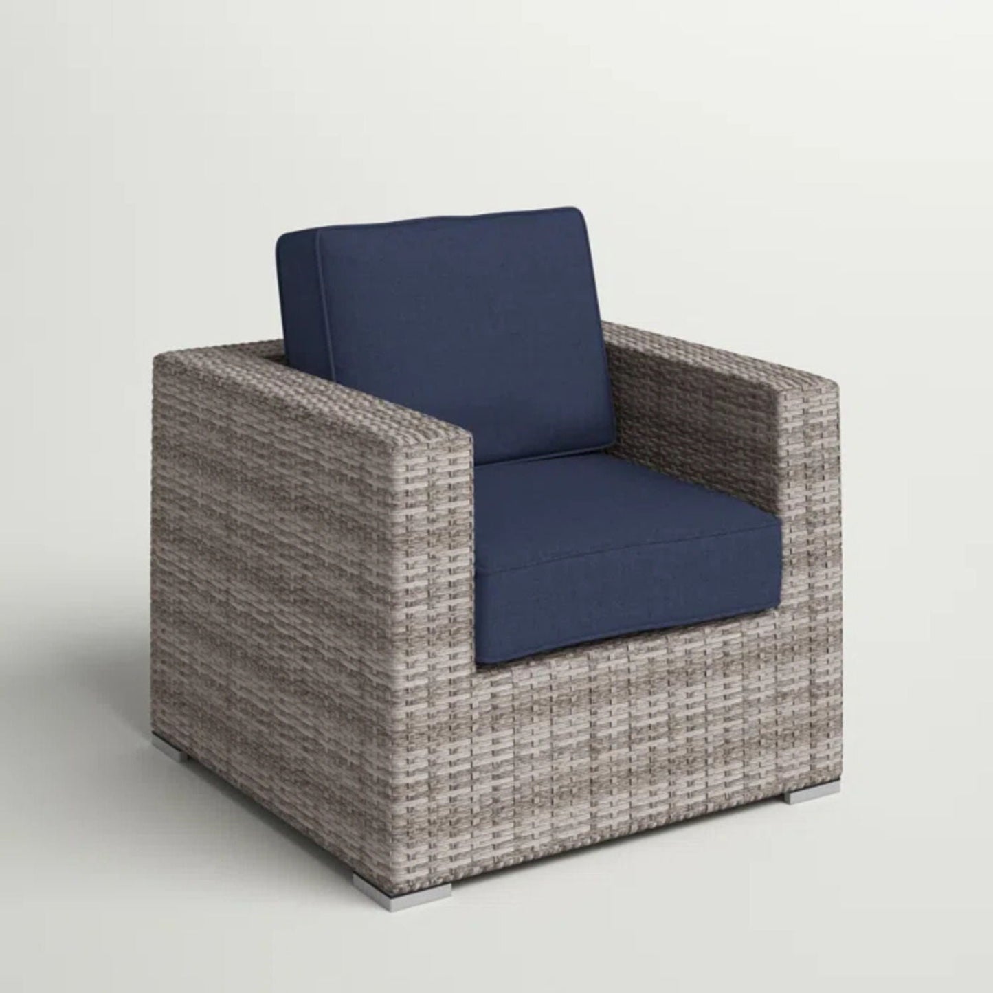 Patio arm chair with navy cushions and light brown woven rattan frame on Tampa Home & Garden Store