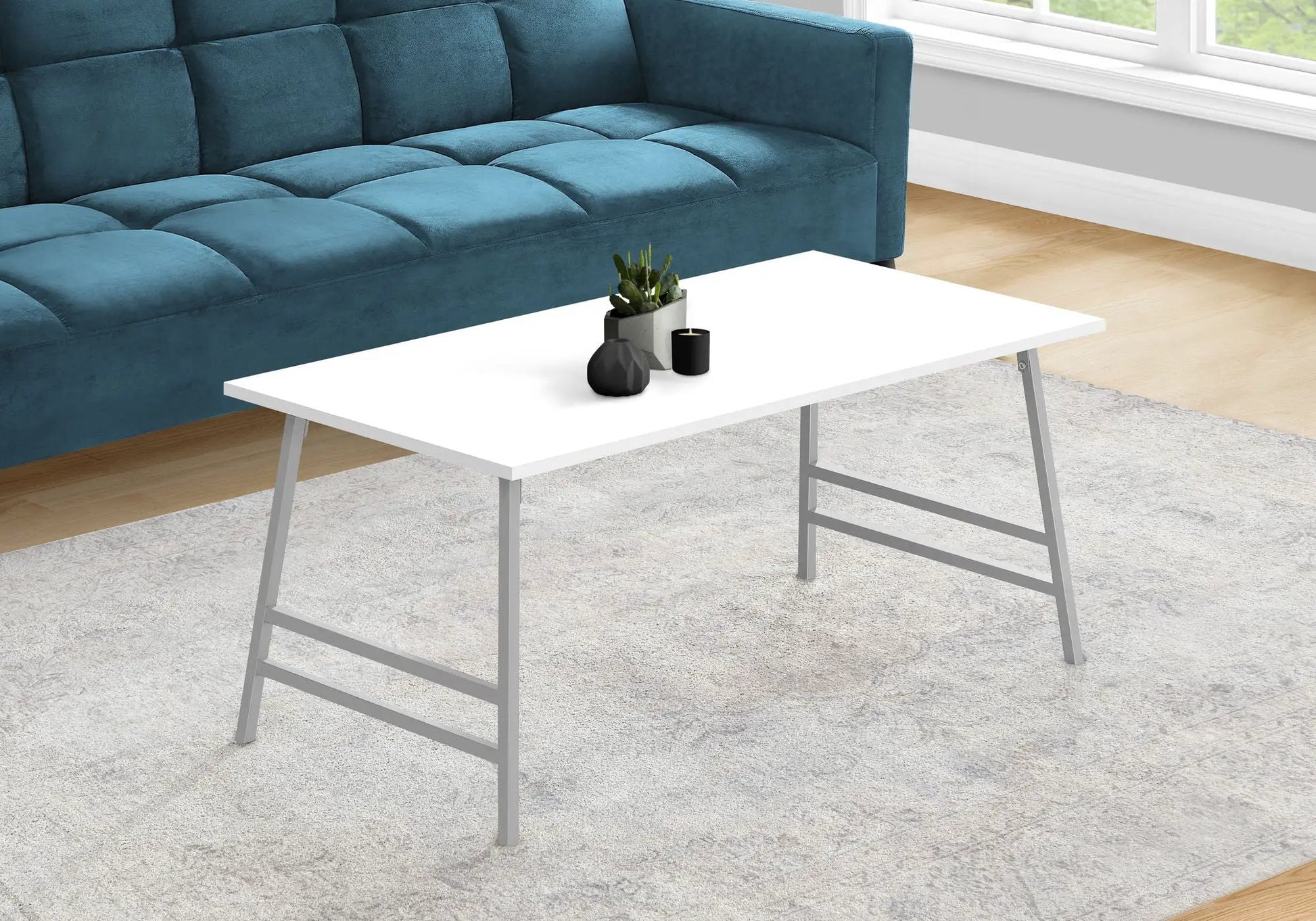 Rectangular modern coffee table in white with metal legs, minimalist plant and candle decor on Tampa Home & Garden Store
