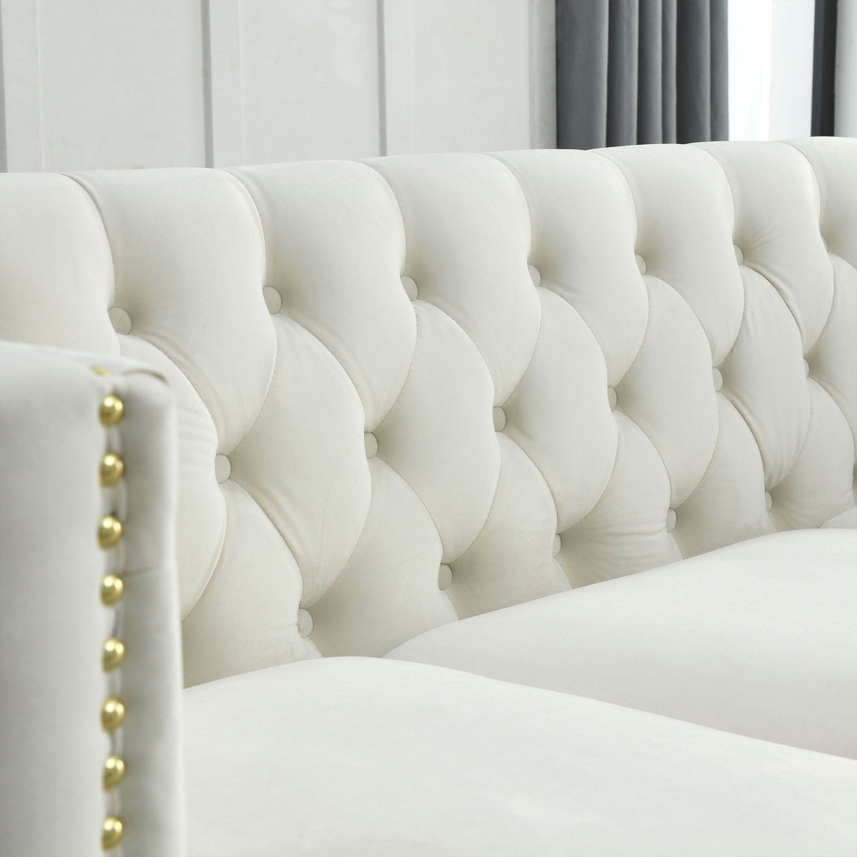White tufted L-shaped corner sofa, 5-seat with button-tufted panels and gold nailhead trim on Tampa Home & Garden Store