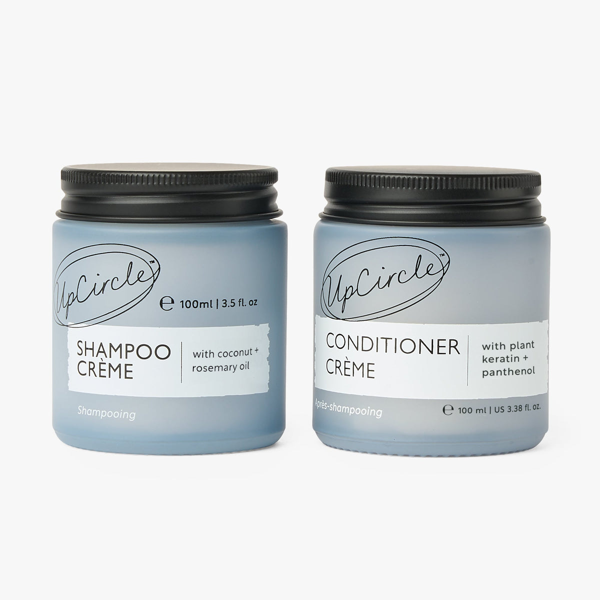 Two UpCircle Shampoo + Conditioner duo bottles, blue plastic with black caps on Tampa Home & Garden Store