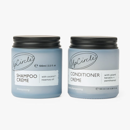 Two UpCircle Shampoo + Conditioner duo bottles, blue plastic with black caps on Tampa Home & Garden Store