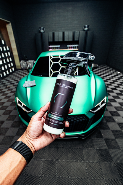 BLACKLINE Waterless Wash spray bottle, white bottle with black label, in front of a green car on Tampa Home & Garden Store