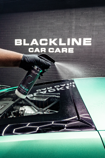 BLACKLINE Waterless Wash spray bottle by Blackline Car Care used on a car by a gloved hand on Tampa Home & Garden Store