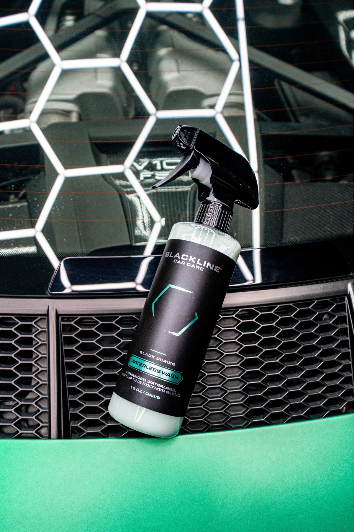 Blackline Waterless Wash spray bottle with black trigger nozzle in front of car grille on Tampa Home & Garden Store