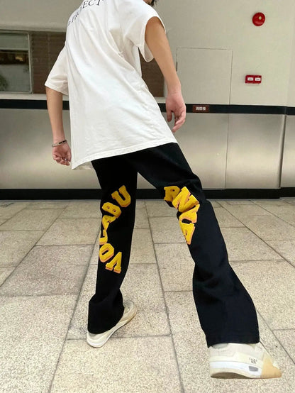 Towel embroidered street fashion jeans trousers, black denim with yellow embroidery on legs on Tampa Home & Garden Store