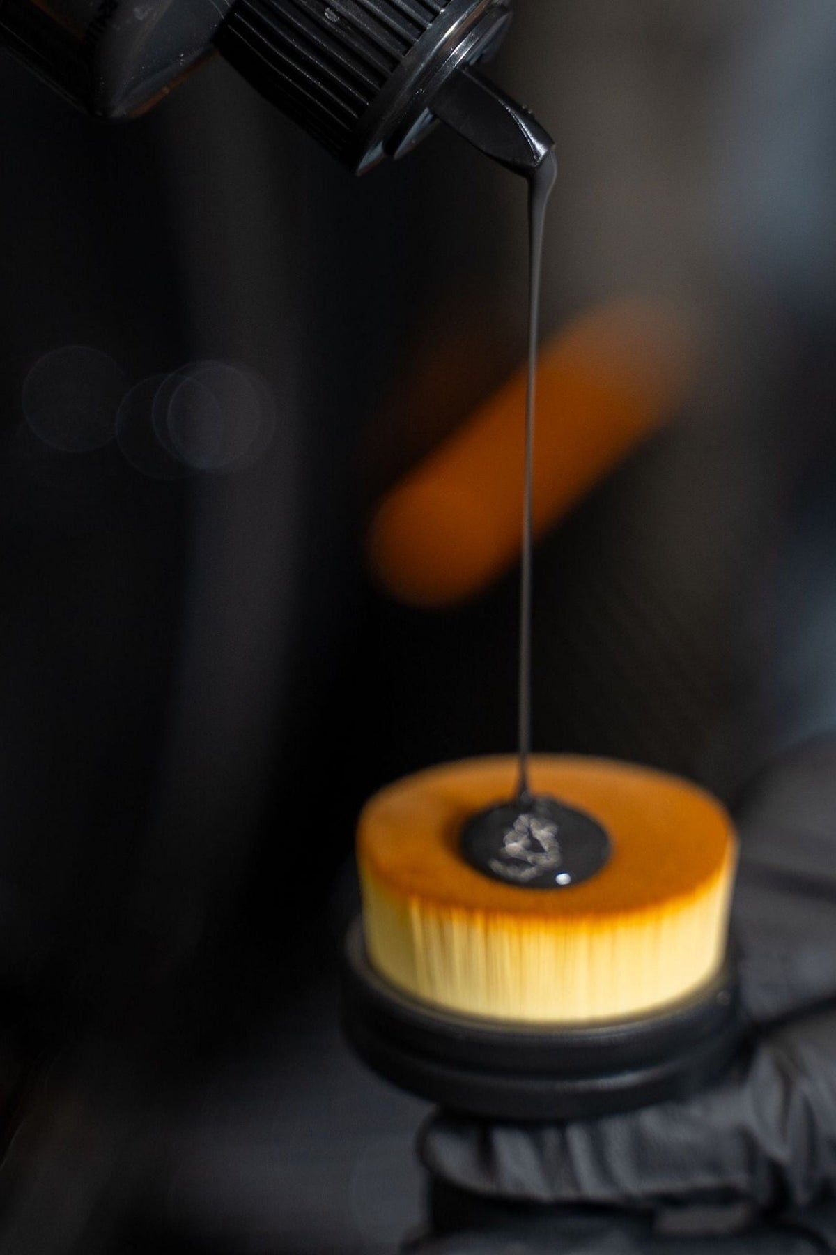 BLACKLINE Tire Shine Applicator Brush with orange cap and dripping tire shine on Tampa Home & Garden Store