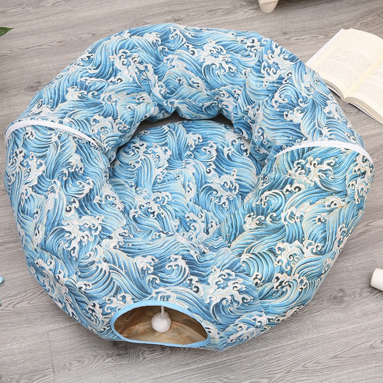 Blue wave-pattern plush cat tunnel sleeping nest, round bed with entrance and white pom-pom on Tampa Home & Garden Store