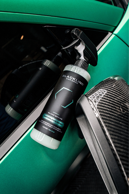 Blackline Car Care Waterless Wash spray bottle with teal accents beside a green car door panel on Tampa Home & Garden Store