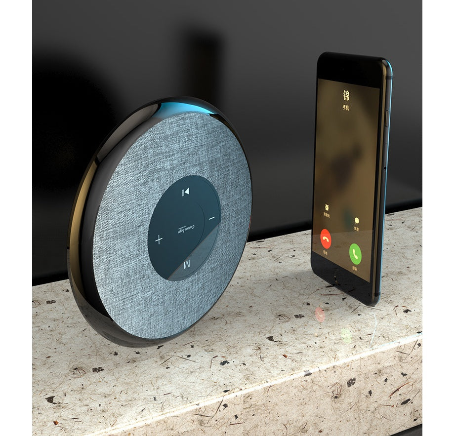 Waterproof Bluetooth speaker by My Store gray fabric with touch controls beside a smartphone on Tampa Home & Garden Store