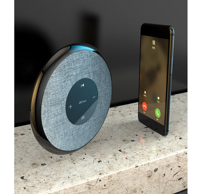 Waterproof Bluetooth speaker by My Store gray fabric with touch controls beside a smartphone on Tampa Home & Garden Store