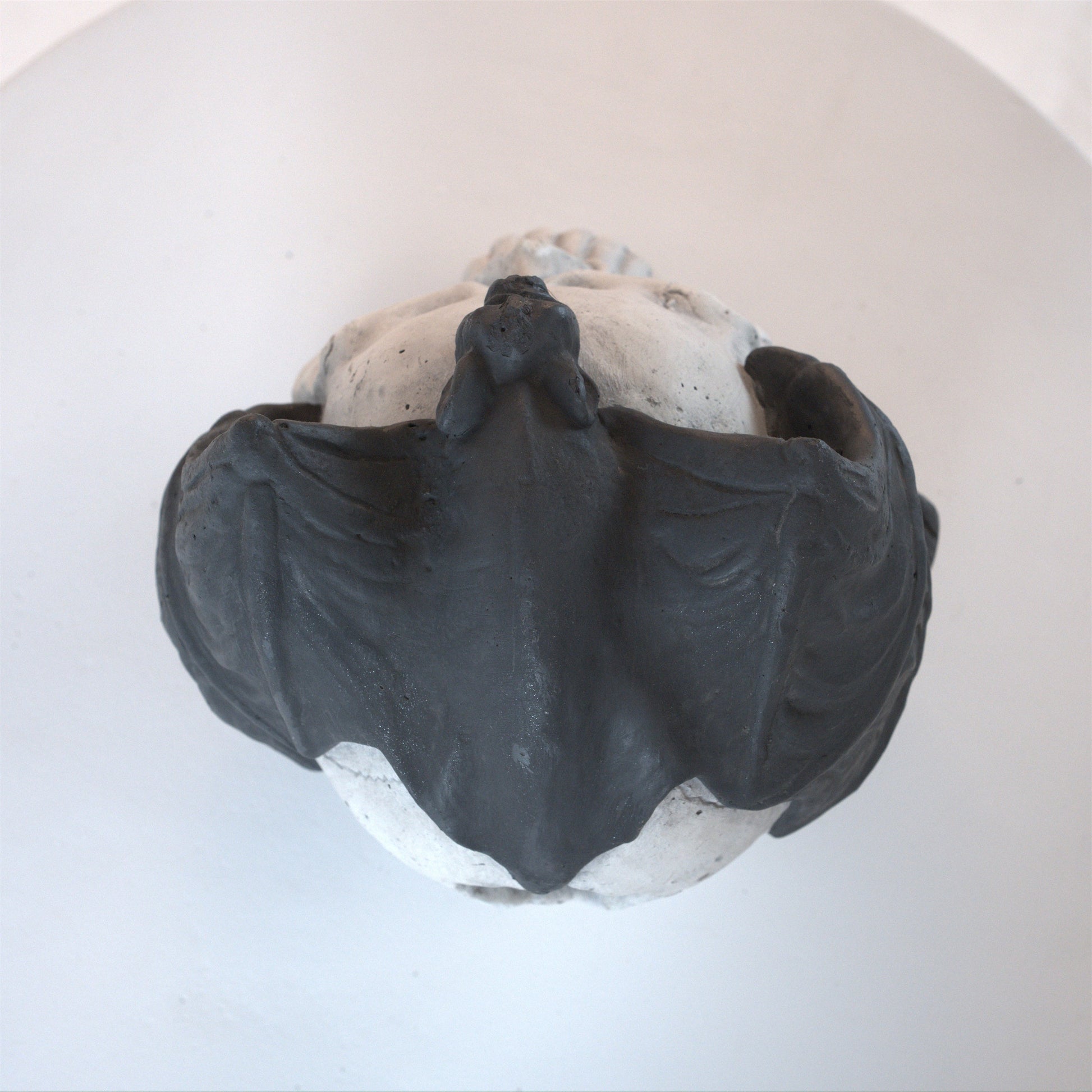 Hand-welded fire pit skull wall art set in dark gray with rough texture on Tampa Home & Garden Store