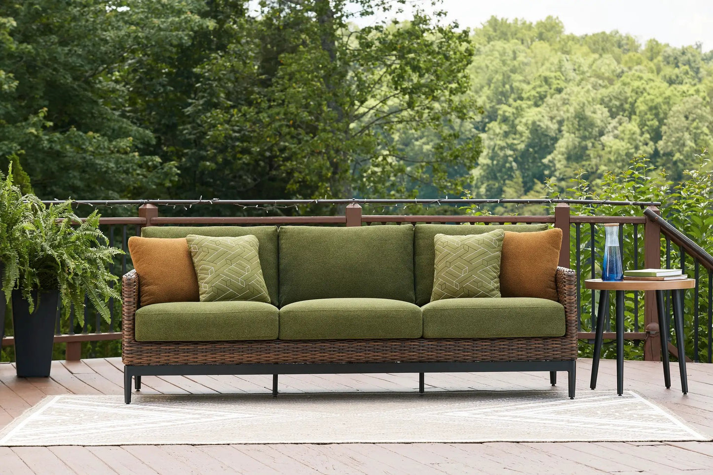 Horizon Hall outdoor sofa with brown/green wicker and olive cushions, green geometric pillows on Tampa Home & Garden Store